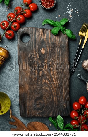 Kitchen banner. A set of vegetables and kitchen utensils on a black table. Free space for text. Top view. Royalty-Free Stock Photo #2344332791