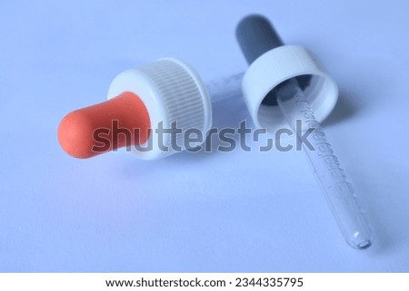 pipette tool for sucking liquids isolated on white background, baby cough medicines, cosmetics, or other liquids