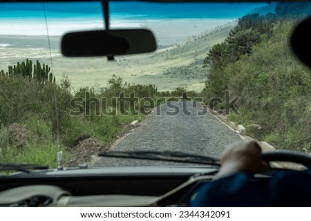 Driver viewpoint from a safari car vehicle of the Ngorongoro Crater in Tanzania, from the road leading to the bottom