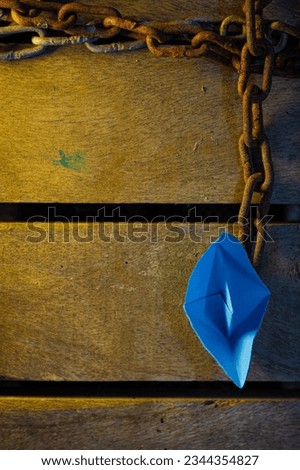 blue paper boat in a wooden table background pictures 