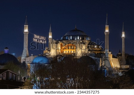 A picture of the Hagia Sophia at night. The sign reads as "God's night".