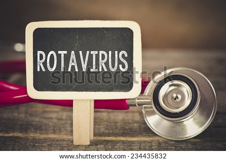 Rotavirus and stethoscope. Medecine concept. Blackboard with word rotavirus and stethoscope Royalty-Free Stock Photo #234435832