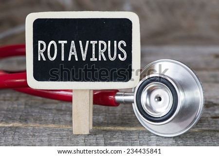 Rotavirus and stethoscope. Medecine concept. Blackboard with word rotavirus and stethoscope Royalty-Free Stock Photo #234435841
