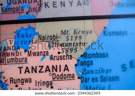Mount Kilimanjaro on political map of globe, travel concept, selective focus, background
