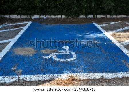 parking for the disabled in blue and a white sign