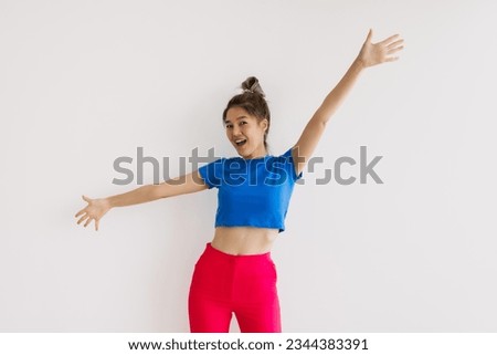 Happy and cheerful asian woman with wide arms open isolated on white.