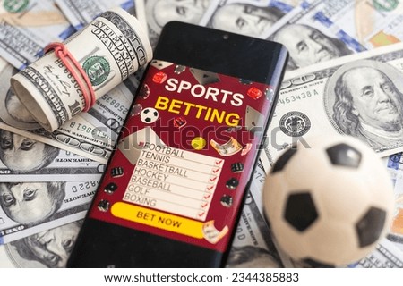 Sports betting concept on smart phone screen on wooden desk. All screen content is designed by me. Flat lay Royalty-Free Stock Photo #2344385883