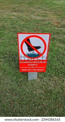 The sign is not to walk on the grass and lawn. Crossed leg. It is forbidden to walk on the grass.