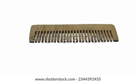 comb made of wood is photographed in closeup, isolated white background
