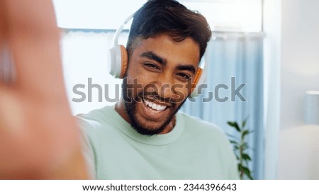 Selfie, man and smiling with headphones for music playlist streaming and cheerful mood in home. Wellness laughing, audio and happy male ready to dance photograph with smile. Royalty-Free Stock Photo #2344396643
