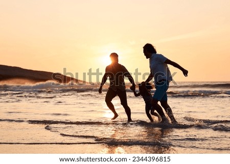 Lgbt family on beach, men and child holding hands at sunset, running in waves and island holiday together. Love, happiness and sun, gay couple on tropical ocean vacation with daughter in silhouette.