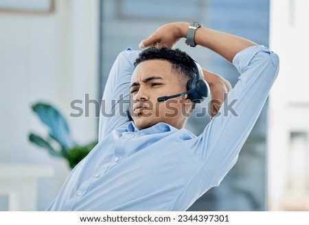 Tired, stretching and man in call center with stress for telemarketing, customer service and sales consulting. Lazy, uncomfortable and male agent on a break for burnout, fatigue or bored at help desk Royalty-Free Stock Photo #2344397301