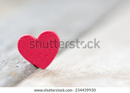 Red heart sign on wooden background
