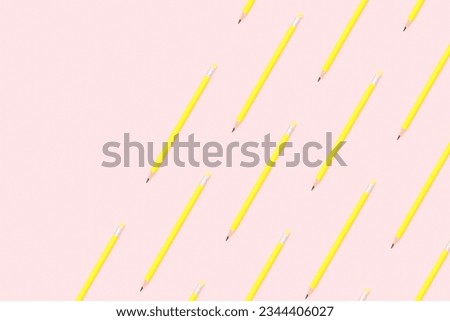 Back to school flat lay on pink background. Yellow pencils repetitive flat lay on pink background