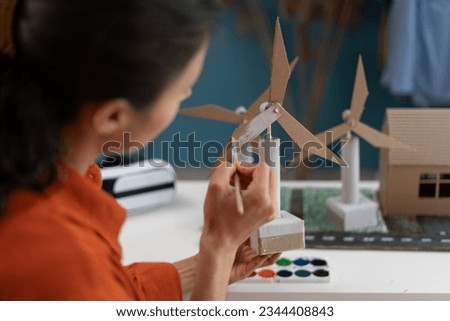 Young woman making renewable energy project working at home. Copy space