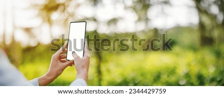 Woman making photo on the smart phone of nature outdoors