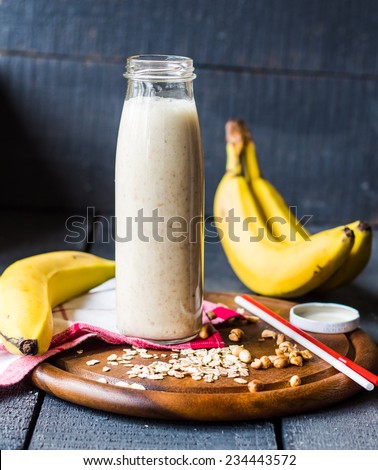 banana smoothie with oat flakes and milk in the bottle,healthy breakfast Royalty-Free Stock Photo #234443572