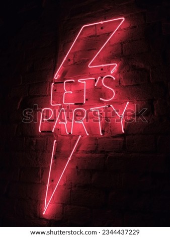 Neon red lightning on the wall with text
