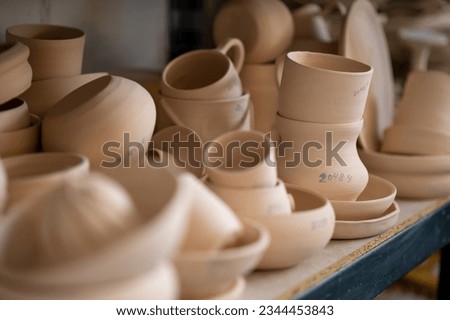 Pottery shelf in studio, creative store clay products, collection and display in workshop.