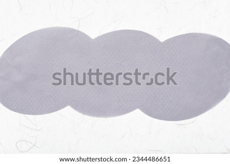 machine-cut scrapbook paper shape (curve bumbs) covered with tracing paper on a light surface Royalty-Free Stock Photo #2344486651