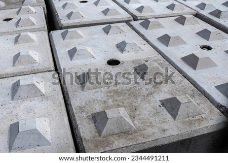 Interlocking pre-cast lego-style concrete blocks designed to hold together by using pre-measured studs and recesses Royalty-Free Stock Photo #2344491211