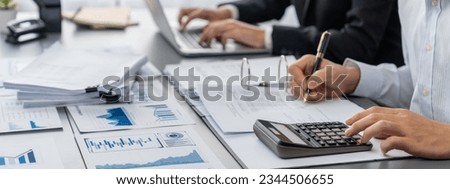 Auditor and accountant team working in office, analyze financial data and accounting record with calculator. Accounting company provide finance and taxation planning for profitable cash flow. Insight Royalty-Free Stock Photo #2344506655
