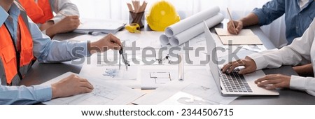 Architect or engineer working on building blueprint, contractor designing and drawing blueprint layout with tool for construction project. Civil engineer and architecture design concept. Insight Royalty-Free Stock Photo #2344506715
