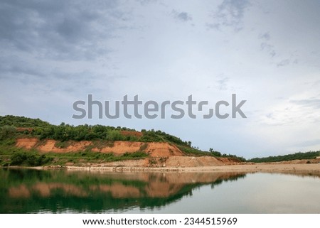 Panorama of a beach of Besenovacko jezero, or lake Besenovo, in Fruska gora mountains, vojvodina, Serbia during a rainy afternoon in Serbia.