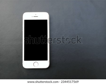 A white smartphone on the left side of grey background
