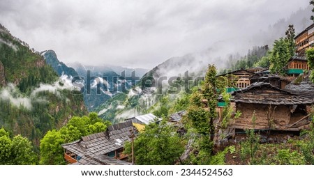 Panoramic view of Jakha, It is a small village also called hangining village because it looks hanging on the Himalayas mountains enroute Rupin Pass trail in Shimla district of Himachal Pradesh, India. Royalty-Free Stock Photo #2344524563