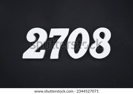 Black for the background. The number 2708 is made of white painted wood. Royalty-Free Stock Photo #2344527071