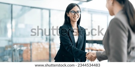 Businesswoman handshake and business people. Successful business concept. Banner background, panoramic view.	