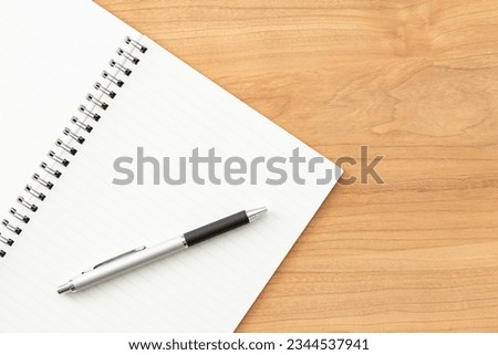 A notebook and pen on the desk.