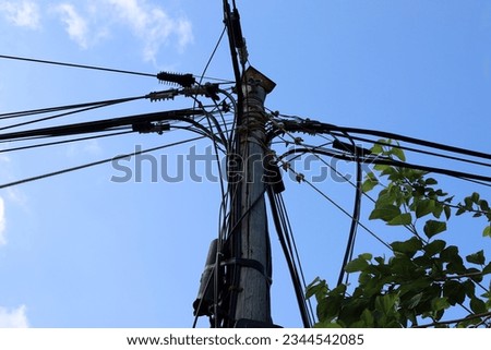 Power electric pole with line wires on insulators.