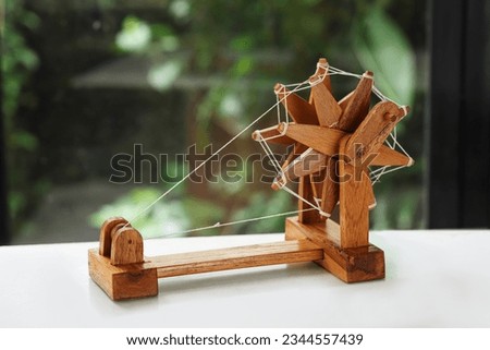 Unique Handmade Wooden Charkha Mini Spinning Wheels - Decorative Gandhi Charkha - Exquisite Wooden Handicraft for Distinctive Royalty-Free Stock Photo #2344557439