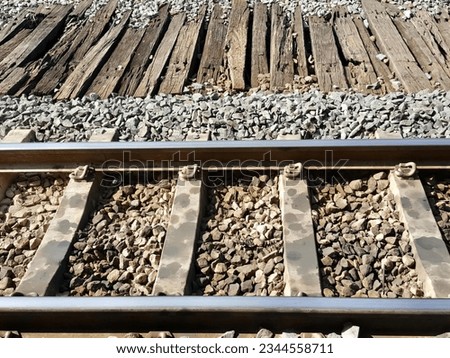 a photography of a train track with a train car on it, there is a train track that has been laid out on the ground.