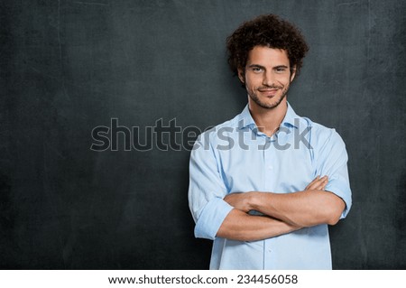 Portrait Of Satisfied Young Man Over Gray Background Royalty-Free Stock Photo #234456058