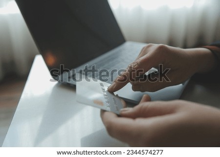 Woman hands holding and using cradit card for shopping online.