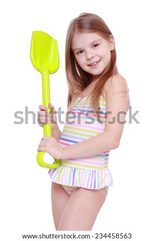 Smiley caucasian little girl wearing swimsuit and holding children paddle isolated over white background
