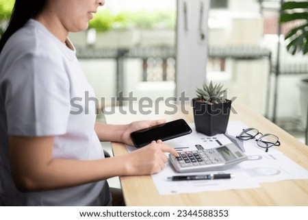 Young woman pressing the calculator for calculate the money for her dept. Asian women are stressed about payment loan problem. people with personal financial crisis concept. Debt, loan concept. Royalty-Free Stock Photo #2344588353