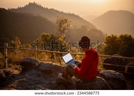 Traveler use laptops connect to the 5G network for work on holidays while relaxing in the mountains. Royalty-Free Stock Photo #2344588775