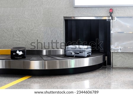 Suitcase luggage on conveyor belt Royalty-Free Stock Photo #2344606789