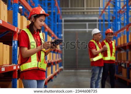 worker working on tablet and checking product list in the warehouse storage