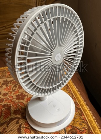 Retro table metal mini fan, little fan, charger fan close up picture. Desktop portable electric high speed rechargeable fan.