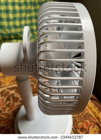 Retro table metal mini fan, little fan, charger fan close up picture. Desktop portable electric high speed rechargeable fan.