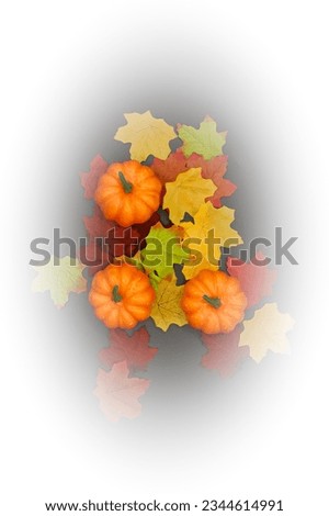 Three pumpkins and colorful leaves design on a light background, with white vignetting, vertical portrait orientation