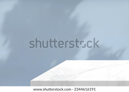 Minimal White Marble Table Corner with Shadow and Light Beam on Pastel Blue Concrete Wall Background, Suitable for Product Presentation Backdrop, Display, and Mock up.