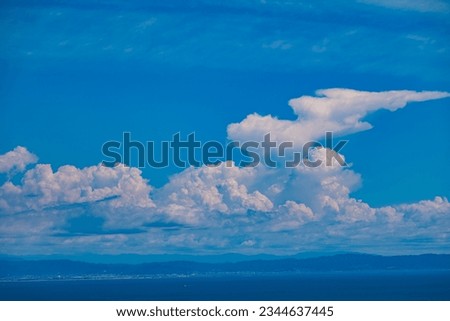 A photo of cumulonimbus clouds characteristic of a Japanese summer. The summer of 2023 in Japan is intensely hot, leading to the formation of very large thunderclouds. Royalty-Free Stock Photo #2344637445