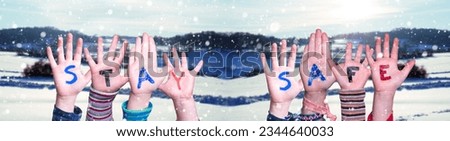 Children Hands Building Word Stay Safe, Winter Background Royalty-Free Stock Photo #2344640033
