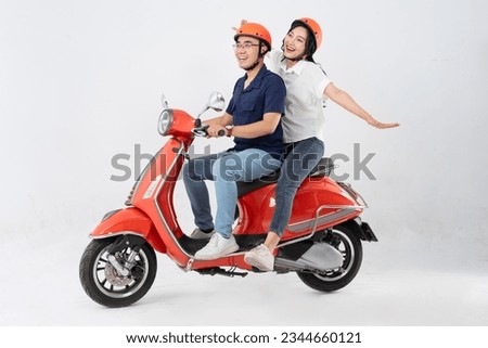 image of asian couple riding scooter on white background Royalty-Free Stock Photo #2344660121